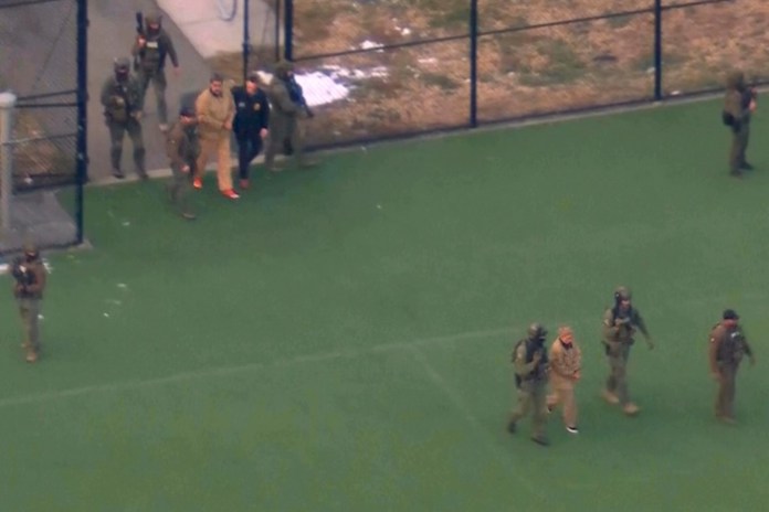 This image taken from video shows Venezuelan President Nicolas Maduro, top left, and his wife Cilia Flores, bottom right, being escorted to board a helicopter for transport to Manhattan Federal Court, Monday, Jan. 5, 2026, in New York. (WABC via AP) Screenshot