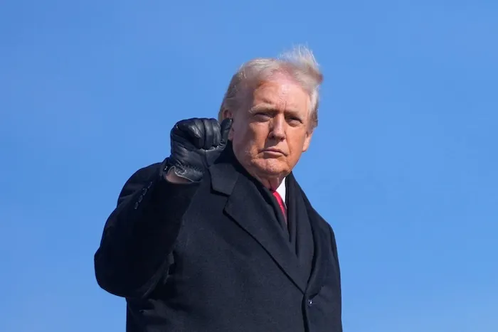 President Donald Trump raises a fist.