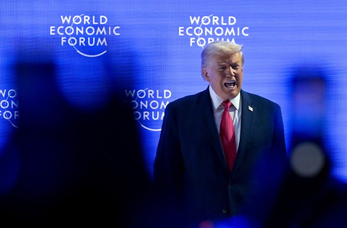 President Donald Trump walks on the stage during the 56th annual meeting of the World Economic Forum in Davos, Switzerland on Jan. 21. (Gian Ehrenzeller/Keystone via AP)