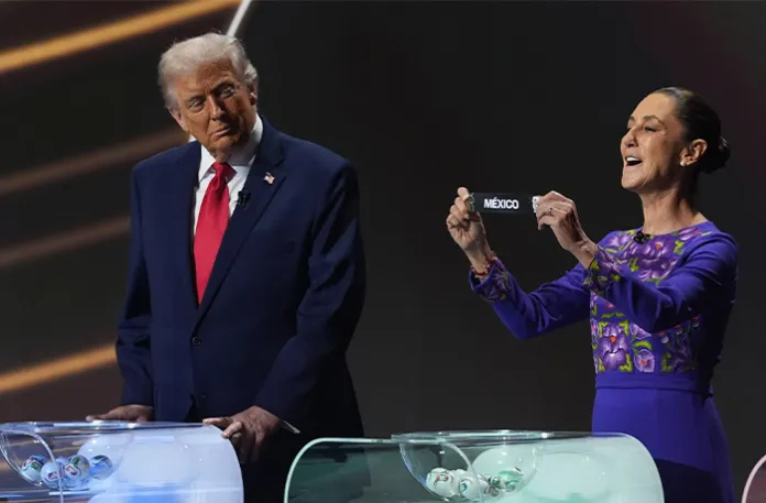 President Donald Trump looks across as Mexican President Claudia Sheinbaum holds up the team name of Mexico during the draw for the 2026 soccer World Cup at the Kennedy Center in Washington on Dec. 5, 2025. (Jacquelyn Martin/AP)