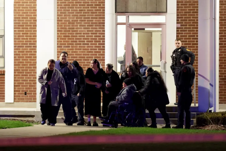 People attending a funeral at the The Church of Jesus Christ of Latter-day Saints in Salt Lake City leave after a fatal shooting in the parking lot.