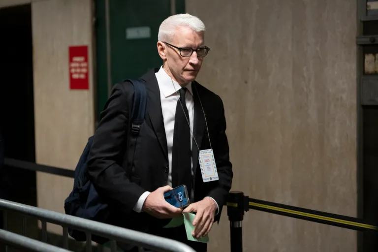 Anderson Cooper walks through a court house in New York