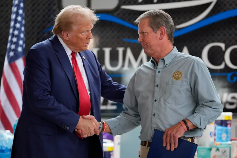 Republican presidential nominee former President Donald Trump shakes hands with Georgia Gov. Brian Kemp