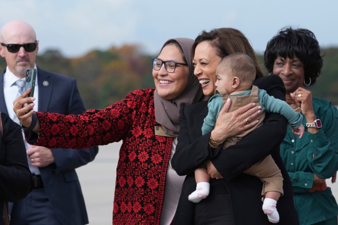 Democratic presidential nominee Vice President Kamala Harris poses for a photo with Chairwoman Nida Allam, Durham County Board of Commissioners, and her son Abdul Allam Aziz, center, as Rep. Valerie Foushee, D-N.C., right, looks on, as she arrives at Raleigh–Durham International Airport.