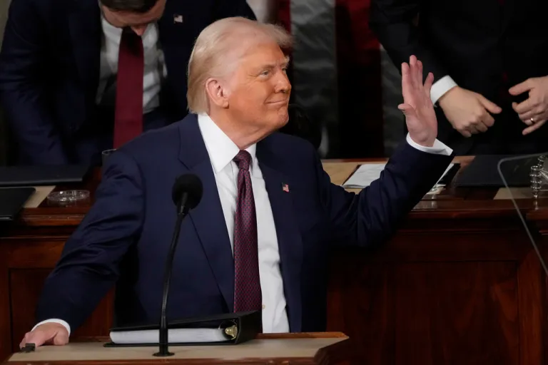 President Donald Trump waves to first lady Melania Trump as he addresses a joint session of Congress.