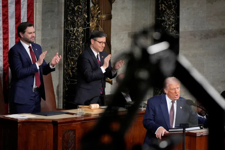Vice President JD Vance, from left, and House Speaker Mike Johnson, R-La., stand to applaud as President Donald Trump addresses a joint session of Congress at the Capitol in Washington, Tuesday, March 4, 2025