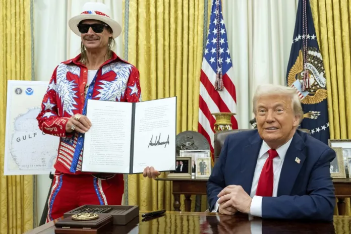 Kid Rock holds a signed executive order regarding ticket scalping after President Donald Trump signed it in the Oval Office of the White House.