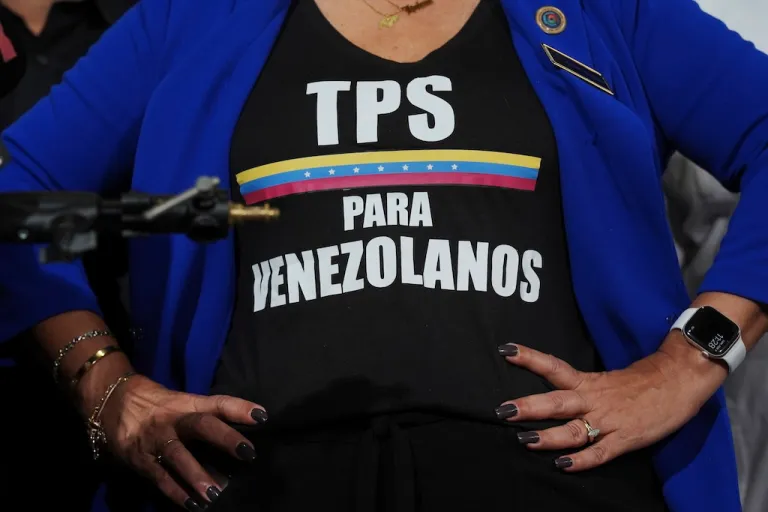 FILE - Activist Helene Villalonga wears a tee-shirt calling for Temporary Protected Status for Venezuelans during a press conference to denounce changes to the protections that shielded hundreds of thousands of Venezuelans from deportation, Feb. 3, 2025, in Doral, Fla. (AP Photo/Rebecca Blackwell, File)
