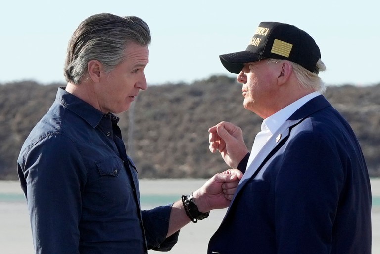 President Donald Trump talks with California Gov. Gavin Newsom after arriving on Air Force One at Los Angeles International Airport