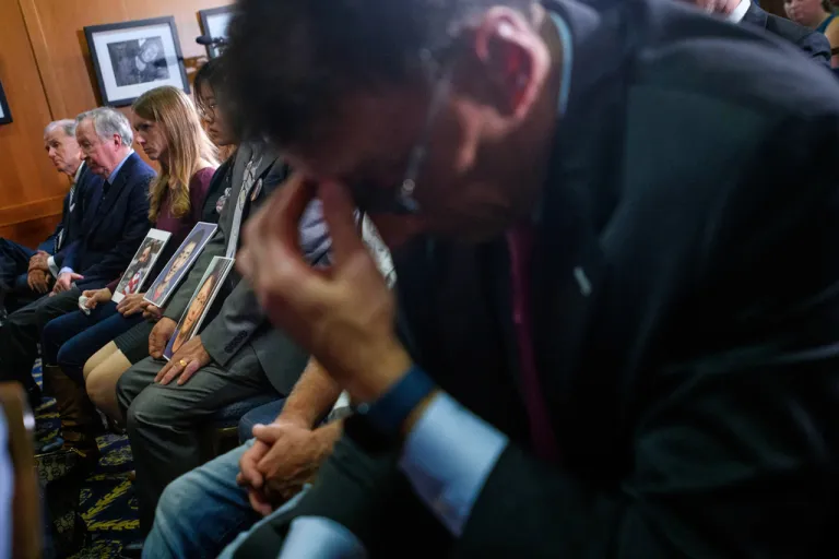Families hold photos of their loved ones who perished on American Eagle flight 5342, during a news conference regarding the Jan. 29, 2025, mid-air collision between American Eagle flight 5342 and a U.S. Army Black Hawk Helicopter, at the National Press Club, Wednesday, Sept. 24, 2025, in Washington. (AP Photo/Rod Lamkey, Jr.)