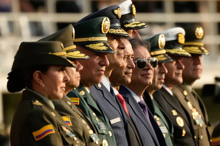 President Gustavo Petro, in sunglasses, and his military staff attend a police ceremony in Bogota, Colombia, Monday, Dec. 15, 2025. (AP Photo/Fernando Vergara)
