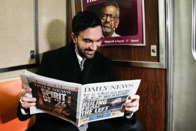 New York City Mayor Zohran Mamdani reads a newspaper on the subway on his way to City Hall in New York, Friday, Jan. 2, 2026.