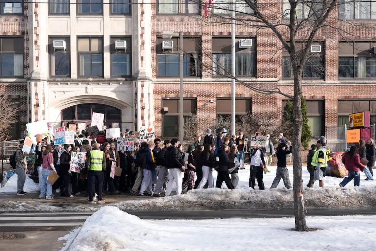 Students walk out of Roosevelt High School during a protest, Monday, Jan. 12, 2026, in Minneapolis. (AP Photo/Jen Golbeck)