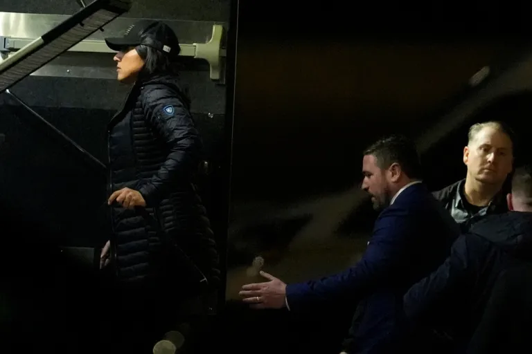 Director of National Intelligence Tulsi Gabbard, left, and FBI Deputy Director Andrew Bailey, enter a command vehicle