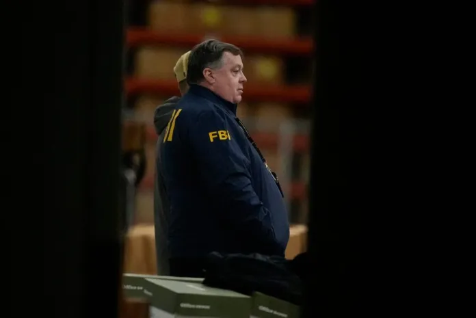 An FBI employee stands inside the Fulton County Election HUB as the FBI takes Fulton County 2020 Election ballots, Wednesday, Jan. 28, 2026, in Union City, Ga., near Atlanta. (AP Photo/Mike Stewart)