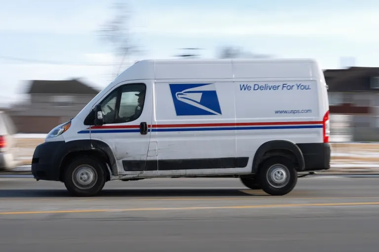 FILE - A United States Postal Service truck drives through Detroit, Feb. 24, 2025. (AP Photo/Paul Sancya, File)