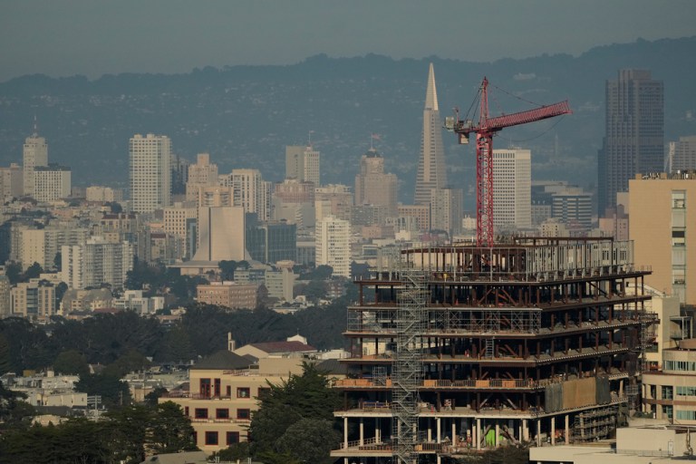 A crane and a construction site are shown in front of the skyline in San Francisco, Thursday, Dec. 4, 2025. (AP Photo/Jeff Chiu)