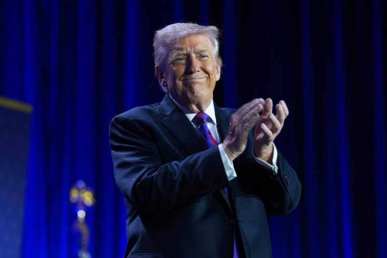 President Donald Trump applauds during the National Prayer Breakfast.