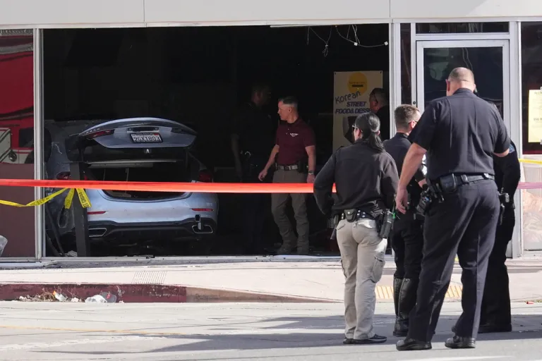 A car is seen inside of a 99 Ranch Market at the scene of a fatal crash Thursday, Feb. 5, 2026, in the Westwood neighborhood of Los Angeles.(AP Photo/Damian Dovarganes)