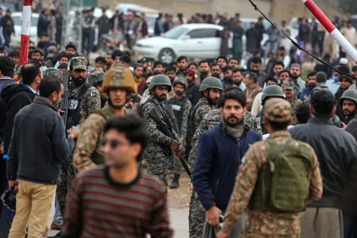 Pakistani paramilitary soldiers control a crowd close to the site of a bomb explosion at a Shiite mosque in Islamabad, Pakistan.