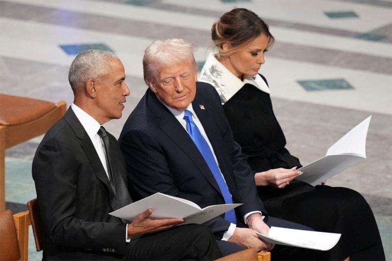 Former President Barack Obama talks with then President-elect Donald Trump as Melania Trump reads the funeral program before the state funeral for former President Jimmy Carter at Washington National Cathedral in Washington.