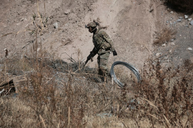 Security forces install barbed wire along the U.S. border in Ciudad Juarez, Mexico