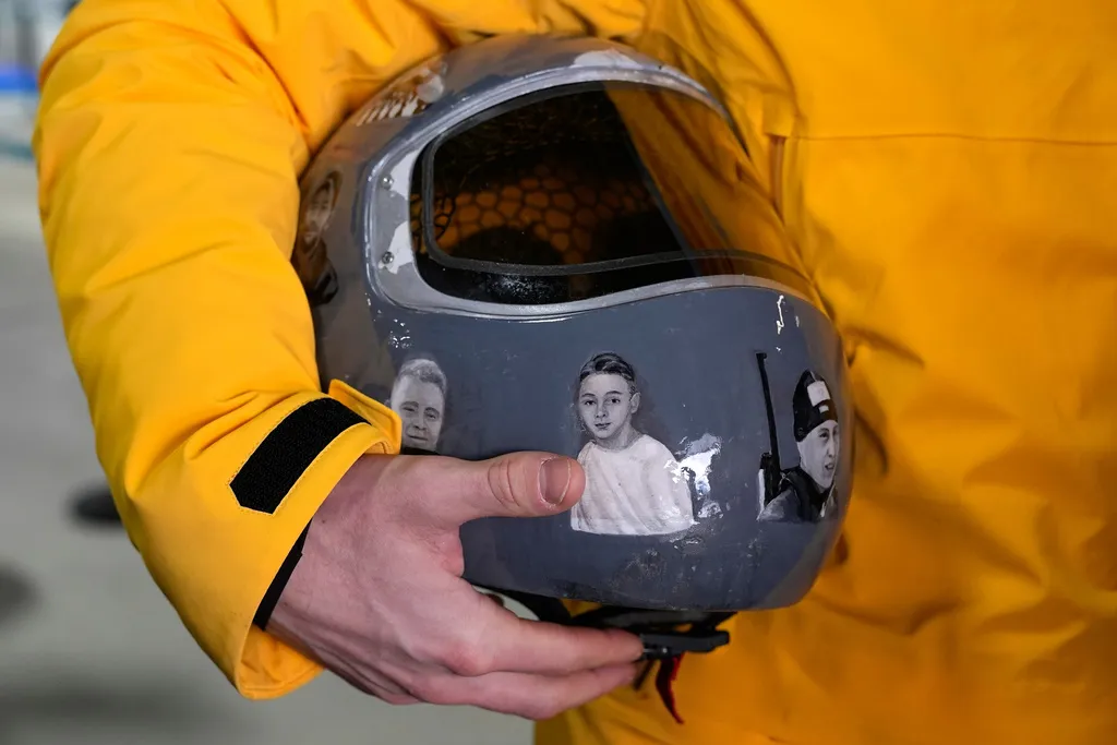 Ukrainian skeleton athlete Vladyslav Heraskevych holds his crash helmet.