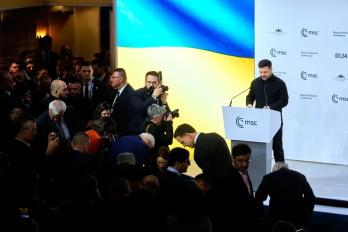 Ukraine's President Volodymyr Zelenskyy, right, prepares to address the audience during a session at the Munich Security Conference in Munich, Germany, Saturday, Feb. 14, 2026. 