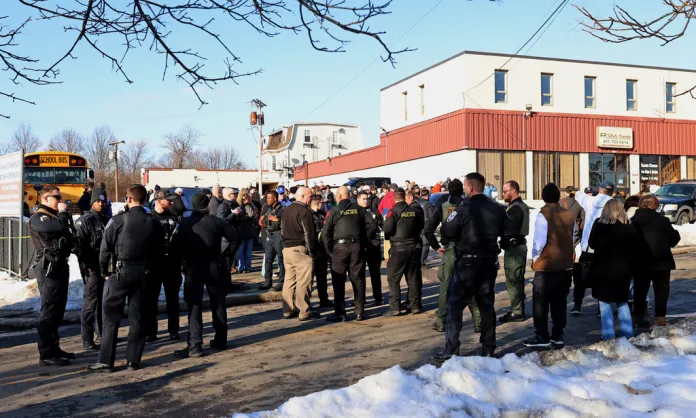 Police gather outside the arena in the aftermath of the shooting