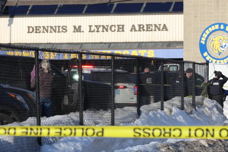 Police and ATF agents stand near the Lynch Arena in Pawtucket, R.I., after a shooting at the ice rink, Monday, Feb. 16, 2026. (AP Photo/Mark Stockwell)