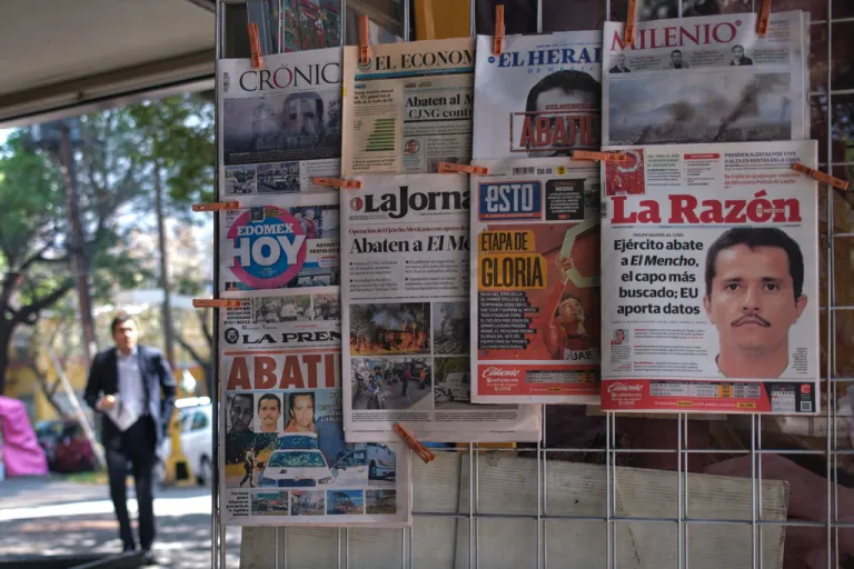 Newspapers hang on display for sale in Mexico City, Monday, Feb. 23, 2026, a day after the Mexican army killed Jalisco New Generation Cartel leader Nemesio Oseguera Cervantes, known as 