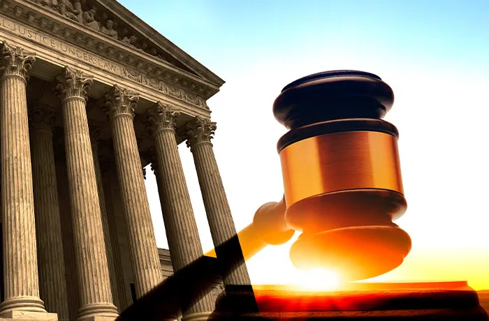 supreme court building with gavel over it amid bursting sunrise colors, depicting tariffs the court shut down against Trump's key economic plan. (Getty Images)