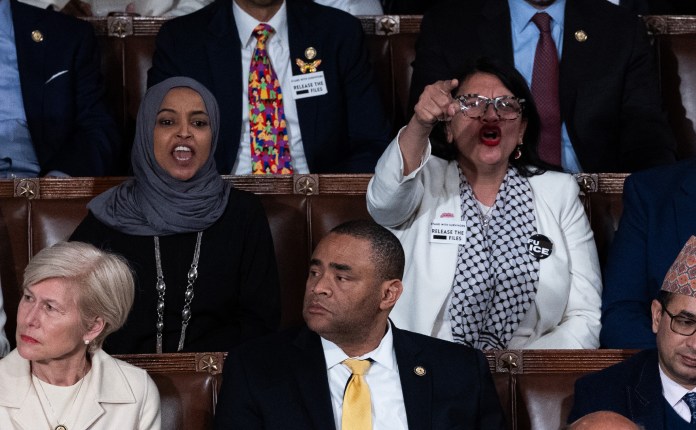Rep. Ilhan Omar (D-MN) and Rep. Rashida Tlaib (D-MI) shout at U.S. President Donald Trump as he delivers his State of the Union address during a Joint Session of Congress at the U.S. Capitol on February 24, 2026, in Washington, DC.