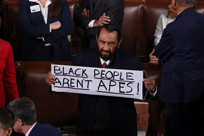 Rep. Al Green (D-TX) holds up a sign at the State of the Union