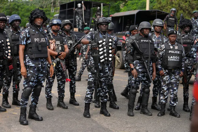 Nigeria police officers stand guard during a candle light procession in honour of all protesters killed nationwide at the recently economic hardship protest, in Lagos, Nigeria, Friday, Aug. 9, 2024. (AP Photo/Sunday Alamba, file)