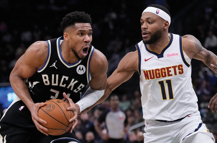 Milwaukee Bucks’ Giannis Antetokounmpo tries to drive past Denver Nuggets’ Bruce Brown during a game on Jan. 23. (Morry Gash/AP)