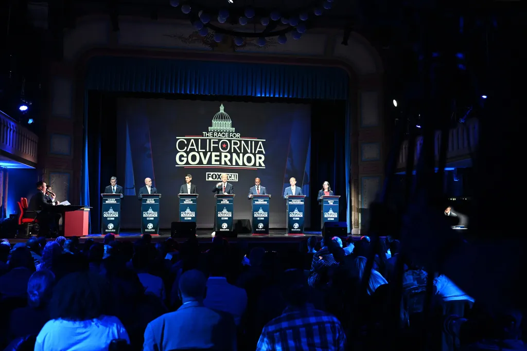From left, Xavier Becerra, Steve Hilton, Matt Mahan, Tom Steyer, Tony Thurmond, Antonio Villaraigosa and Betty Yee stand on the stage during the California gubernatorial candidate debate