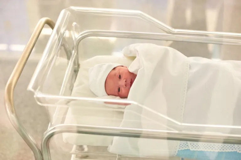 Newborn baby in a hospital recovery room family children birth rate birthrate