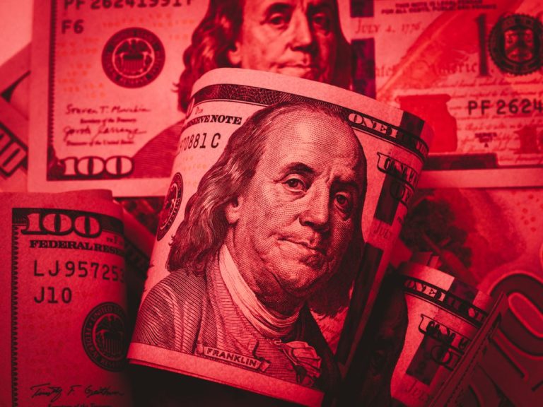 Money , cash , dollars Down stock market, dollar weakens, business financial, inflation, online Investment concept. 100 USA American dollars cash bill banknote with Benjamin Franklin's portrait, red tone background.