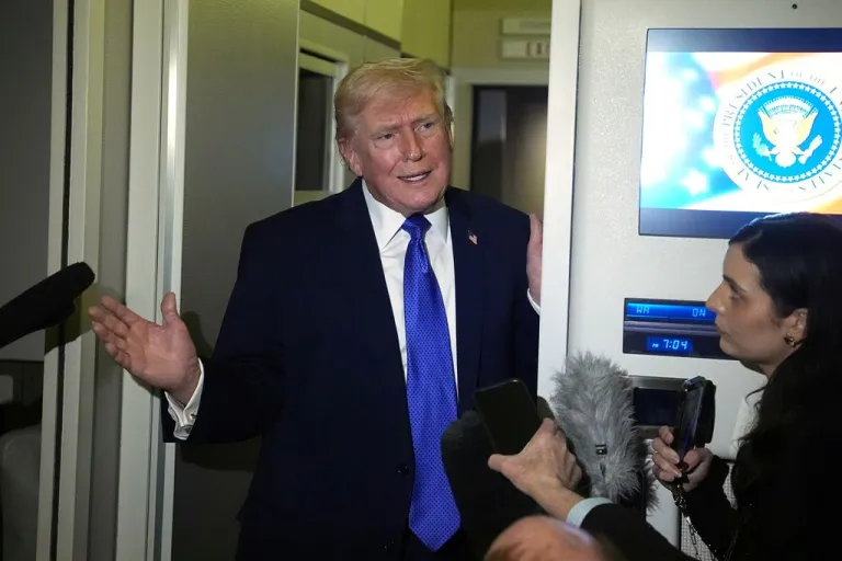Trump speaks to reporters on Air Force One.