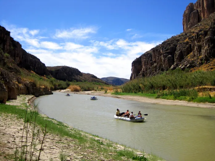 This March 25, 2011 photo shows rafts piloted by guides from Far Flung Outdoor Center of Terlingua, Texas, as they float through a canyon carved by the Rio Grande through Big Bend National Park, Texas. The river outfitter and San Antonio Chef, Francois Maeder, conduct unique gourmet trips on the river offering white-linen table service in the wilderness area, hours from civilization. (AP Photo/Michael Graczyk)