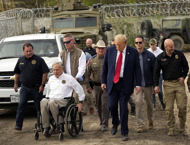 Republican presidential candidate former President Donald Trump walks during a visit to Shelby Park on the U.S.-Mexico border, Thursday, Feb. 29, 2024, in Eagle Pass, Texas. At left is Mike Banks, special adviser to the governor on border matters, and Texas Gov. Greg Abbott, second from left. (AP Photo/Eric Gay)