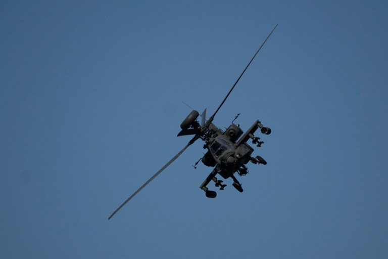 An Apache helicopter flies as soldiers take part in the U.S.-led Immediate Response 25 military exercise