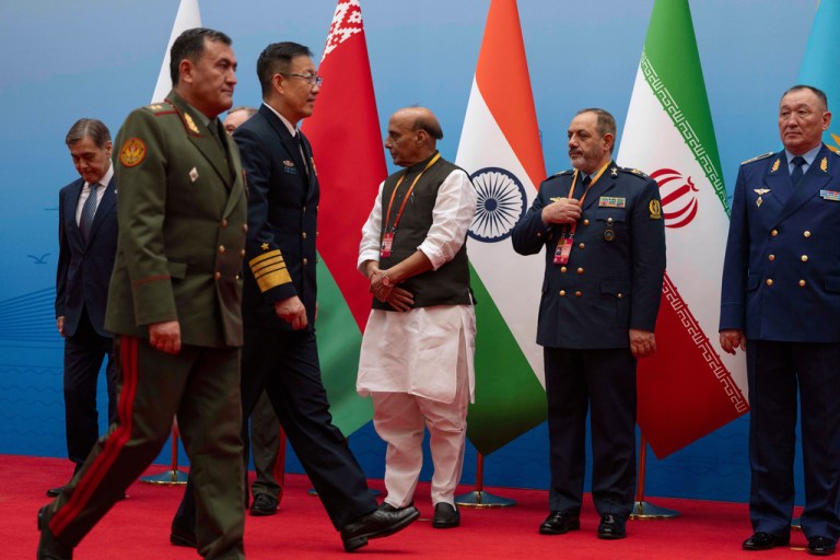 Chinese Defense Minister Dong Jun, third left, walks near Iran Defense Minister Aziz Nasirzadeh, second right, as they attend a group photo.