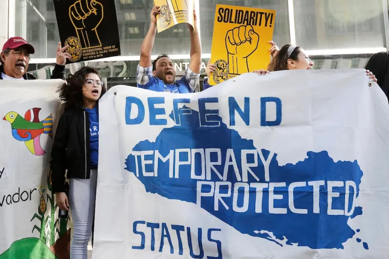 FILE - Supporters of temporary protected status immigrants hold signs and cheer at a rally before a conference announcing a lawsuit against the Trump administration over its decision to end a program letting immigrants live and work legally in the United States outside of a federal courthouse in San Francisco, March 12, 2018. (AP Photo/Jeff Chiu, File)