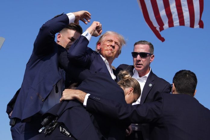 Republican presidential candidate Donald Trump surrounded by U.S. Secret Service agents.