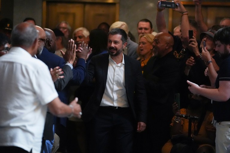 Former Transportation Secretary Pete Buttigieg makes his way through the crowd before speaking at a rally at the Statehouse in Indianapolis