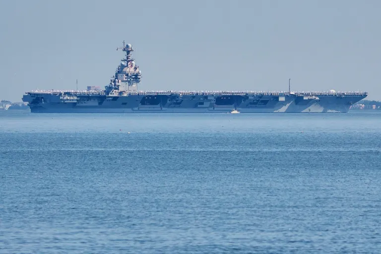 The USS Gerald R. Ford aircraft carrier leaves Naval Station Norfolk, June 23, 2025, in Norfolk, Va. (AP Photo/John Clark, File)