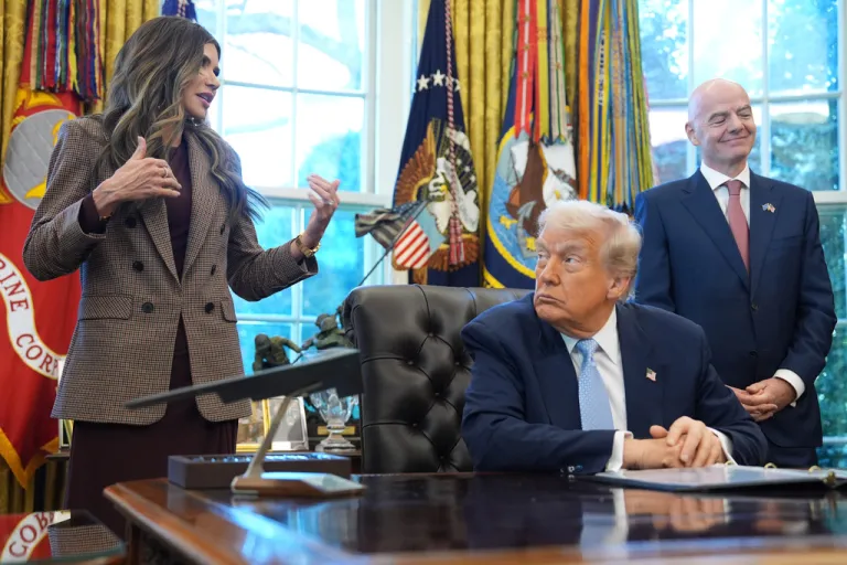 President Donald Trump and FIFA President Gianni Infantino listen as Homeland Security Secretary Kristi Noem speaks during a meeting with the White House task force on the 2026 FIFA World Cup in the Oval Office of the White House, Monday, Nov. 17, 2025, in Washington.