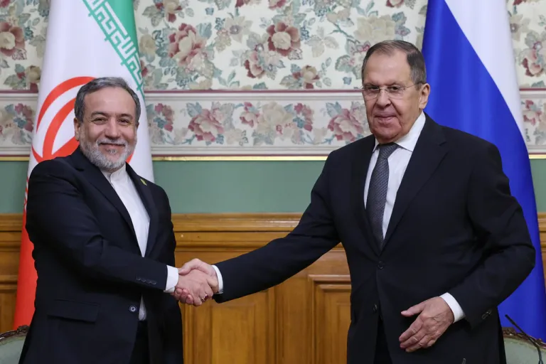 Russian Foreign Minister Sergey Lavrov, right, and Iranian Foreign Minister Abbas Araghchi shake hands